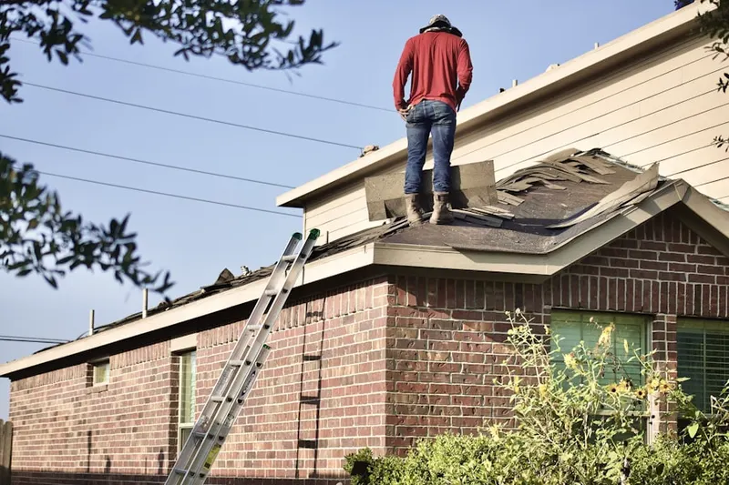 Professional roofer working on a residential roof in Montgomery Greeny